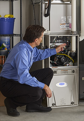 a technician inspecting a furnace Farmers Branch TX