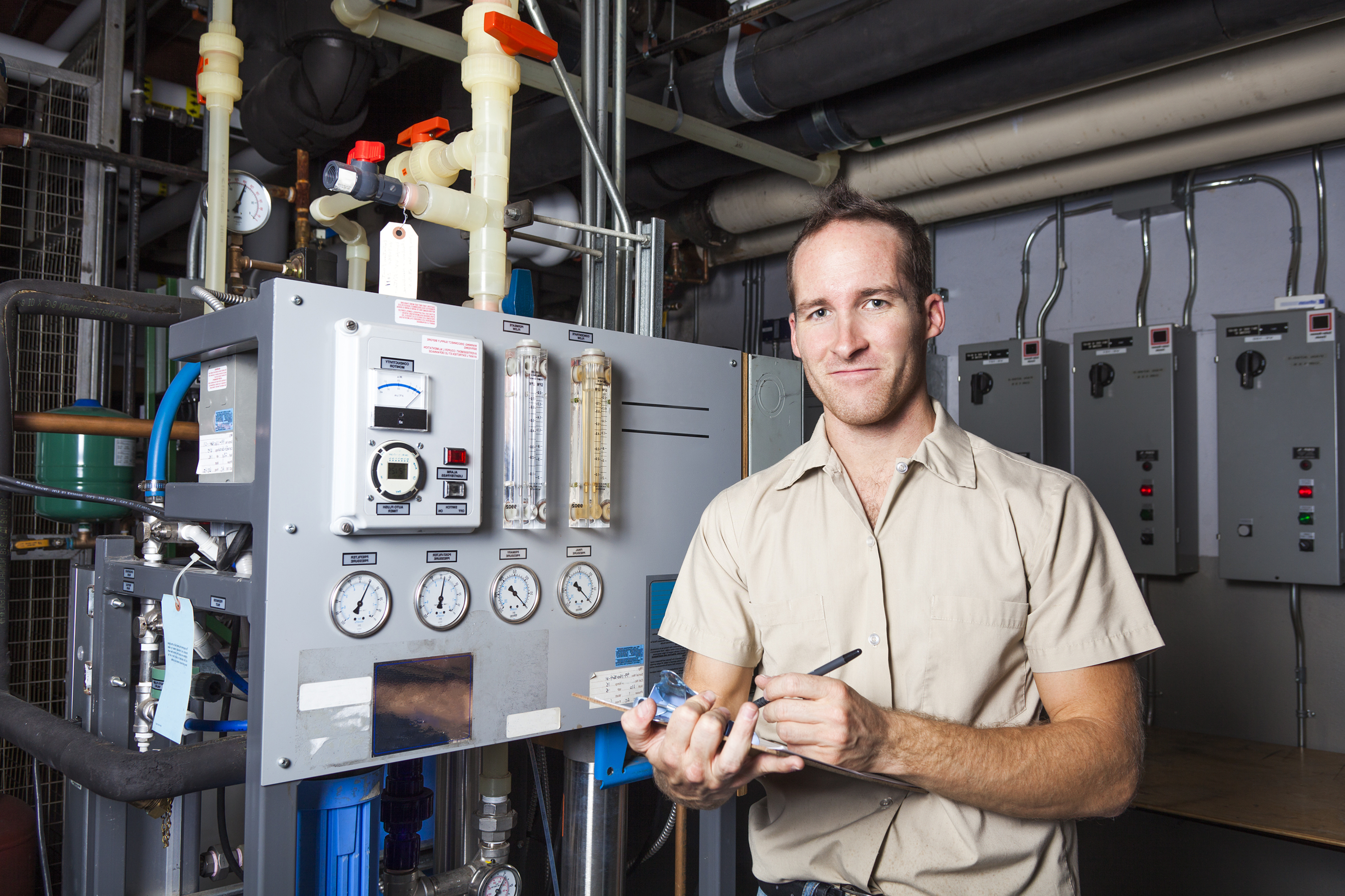 A technician in front of a control panel
