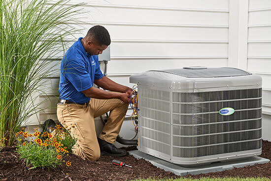 a technician working on an outdoor AC unit Farmers Branch TX