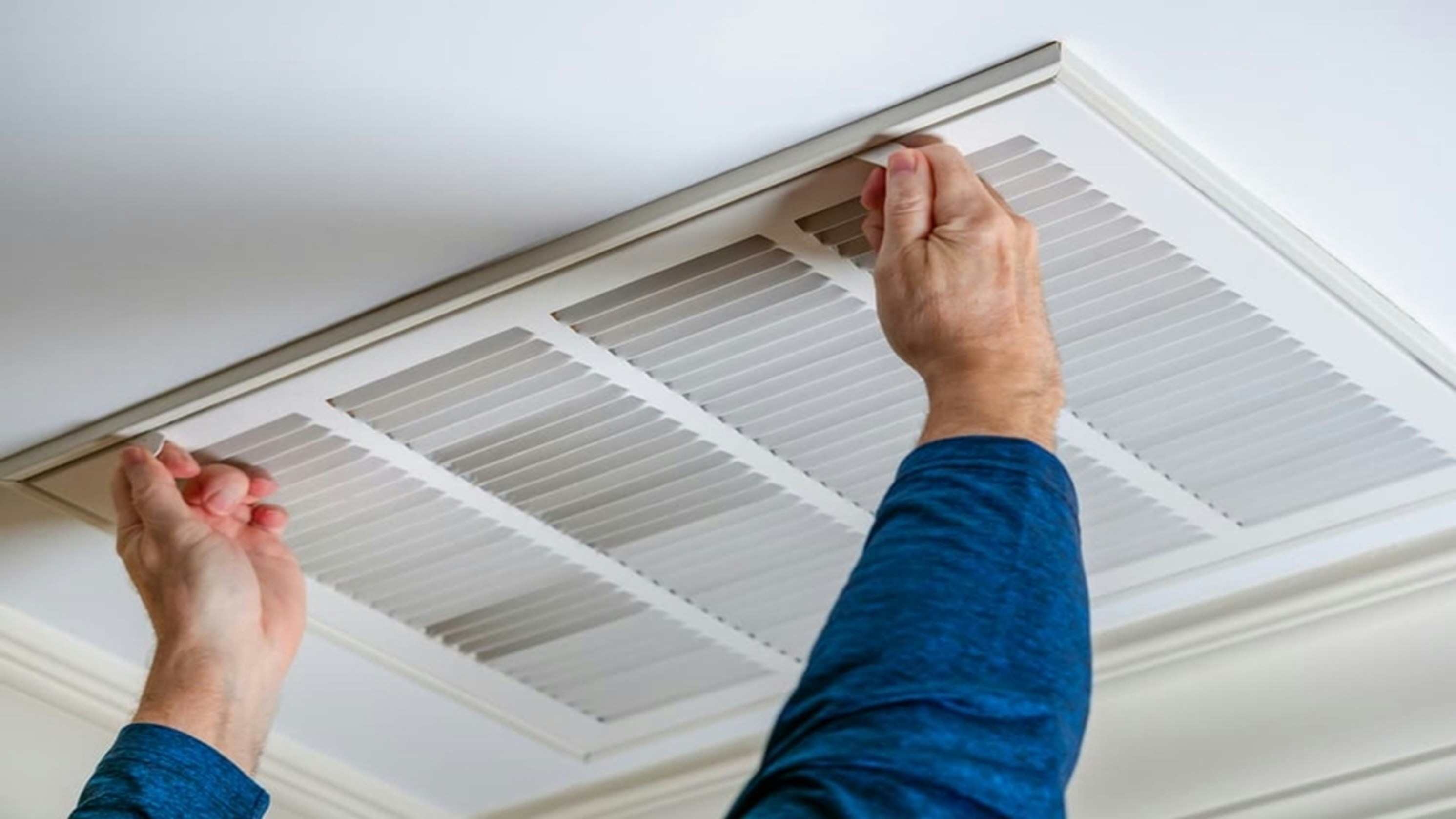 A technician in Farmers Branch replacing a vent